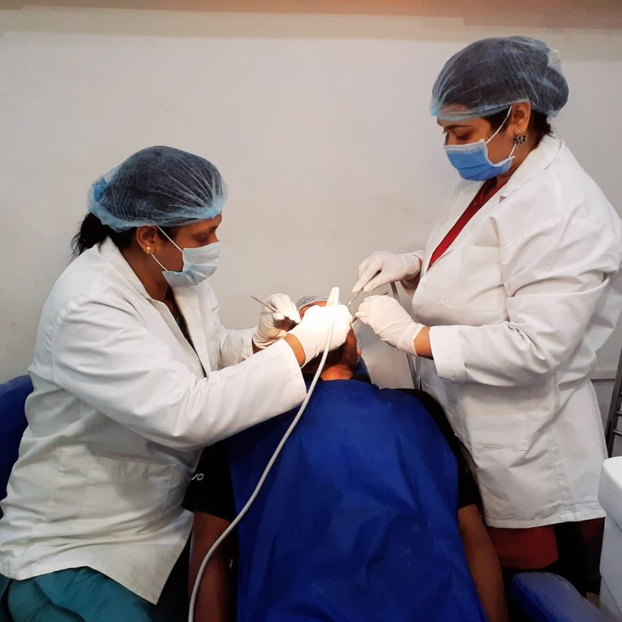 At a dental clinic, two female dentists are performing root canal procedures.