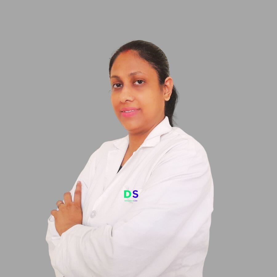 A root canal expert lady dentist is standing in clinic wearing white apron.